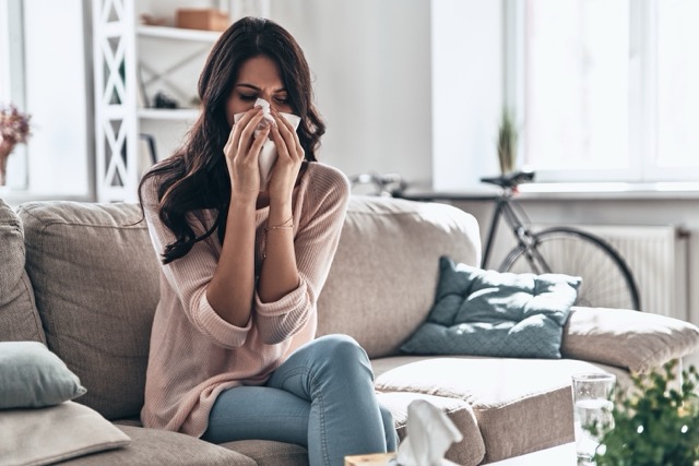 woman on couch with allergies